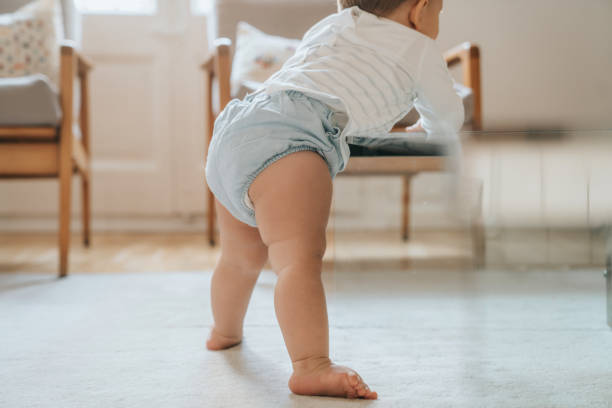 istock Baby standing up for the first time 1275169722