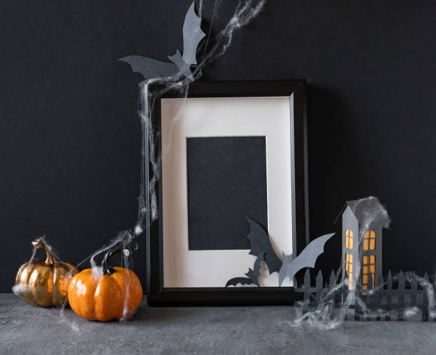istock Modern Halloween background with pumpkins, bats and black frame on dark background. Halloween party invitation card mockup. 1275175064