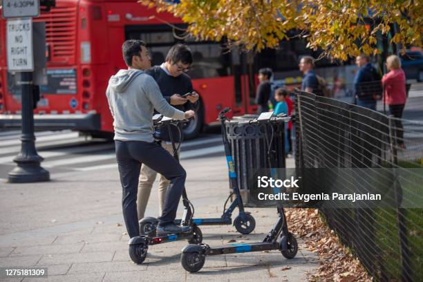 Two Men Choosing Electric Scooter For City Ride Autumn Fall Season Stock Photo - Download Image Now