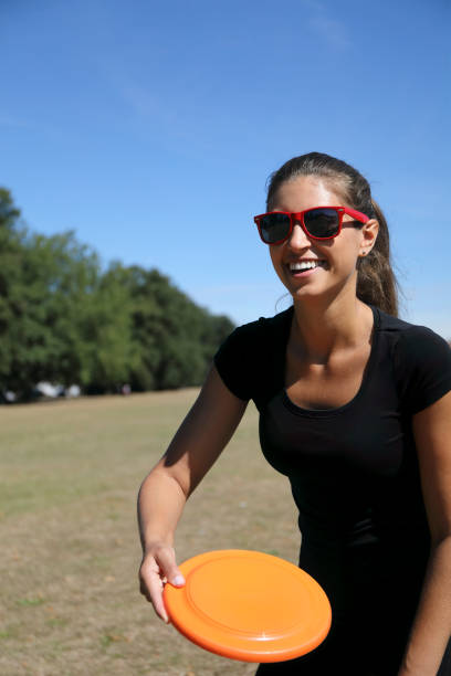 istock Orange plastic frisbee toy thrown by beautiful Russian model 1275185932