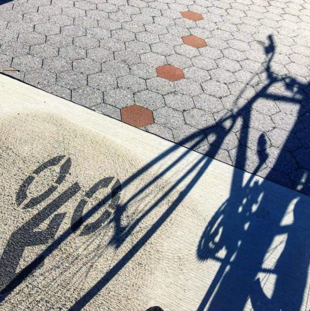 Shadow of Bicycle and Bicycle Crossing Sign stock photo