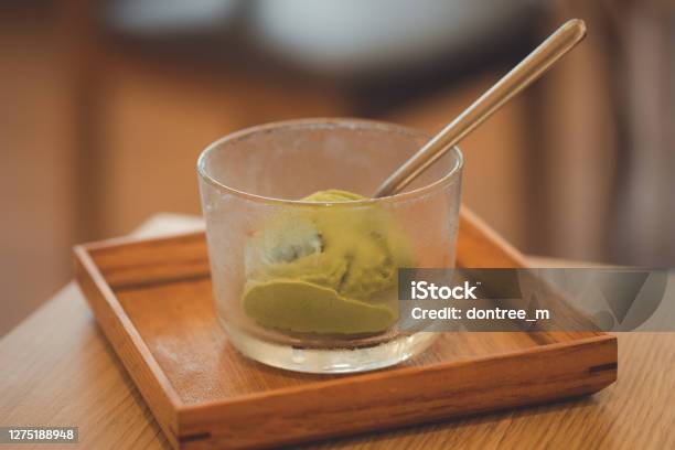 ウッドトレイに盛り付けガラスボウルに入れた緑茶抹茶アイスクリームスクープ