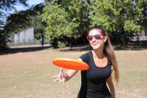 istock Orange plastic frisbee toy thrown by beautiful Russian model 1275196494