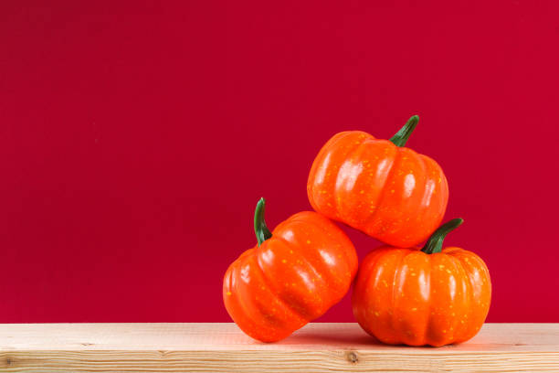 istock Halloween holiday concept with pumpkin decor on wooden table. 1275196754