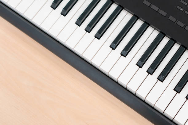 istock Midi keyboard piano on wooden table 1275199428