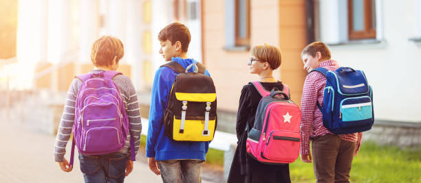 istock Children with rucksacks standing in the park near school 1275200423