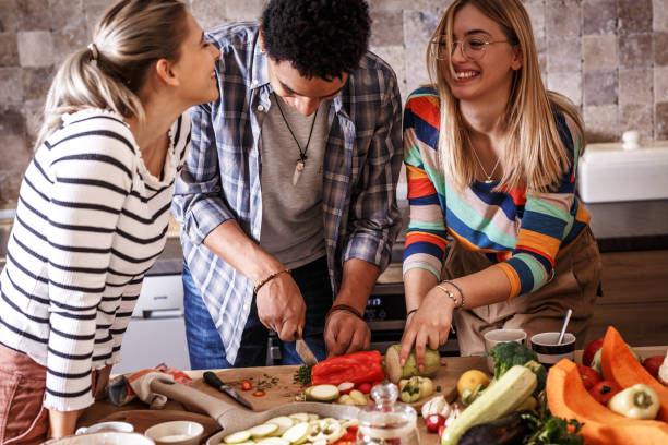 istock Group of friends preparing vegetarian meal. 1275228318