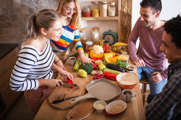 istock Group of friends preparing vegetarian meal. 1275228635