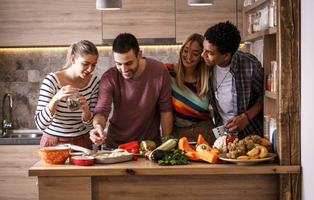 istock Group of friends preparing vegetarian meal. 1275229381