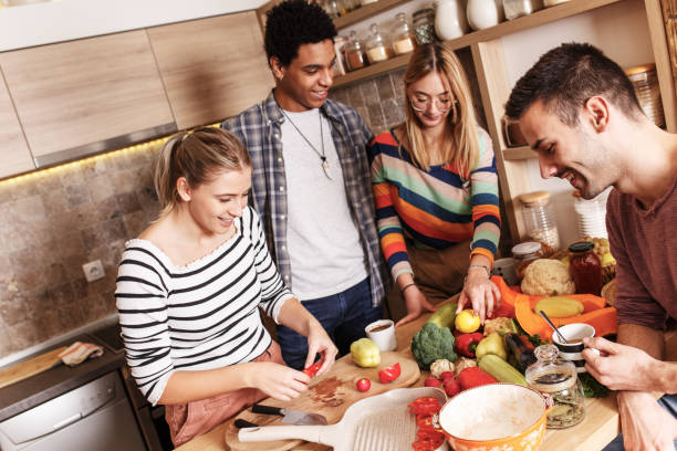 istock Group of friends preparing vegetarian meal. 1275229814