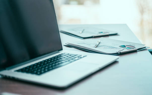 istock close up. a laptop computer and financial graph on the desktop 1275236547