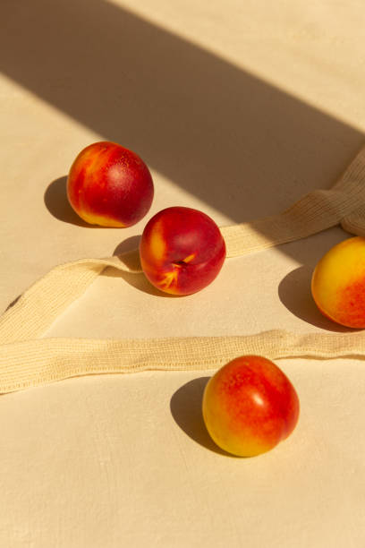 istock Fresh juicy nectarines in a cotton bag on a white background 1275236709