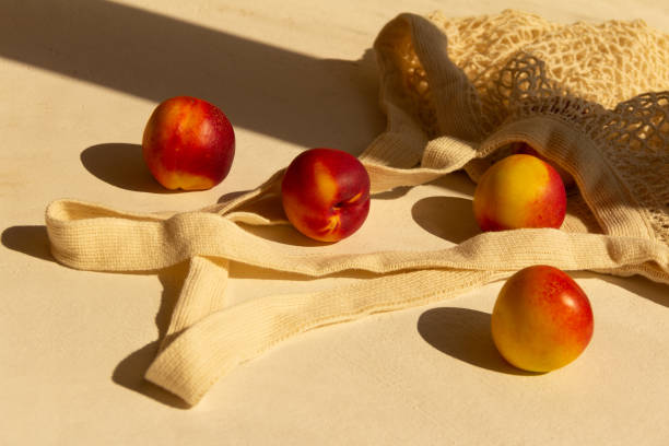 istock Fresh juicy nectarines in a cotton bag on a white background 1275237287
