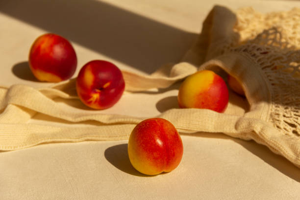 istock Fresh juicy nectarines in a cotton bag on a white background 1275237437