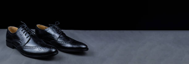 istock men's shoes black background 1275241284