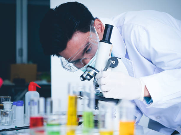 istock Asian male scientist Is working seriously Chemistry experiment With a microscope In the laboratory 1275244019