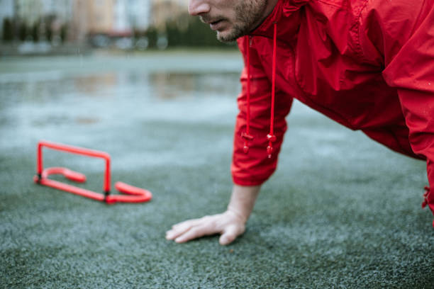 istock Man in red wind jacket is training on rainy day 1275254879