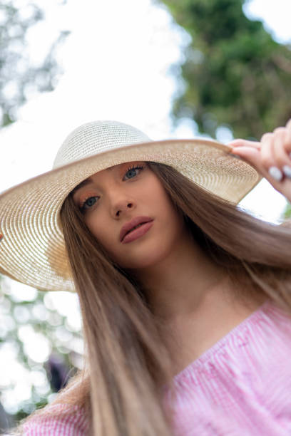 istock Beautiful blonde young lady in straw hat in the 1275256196