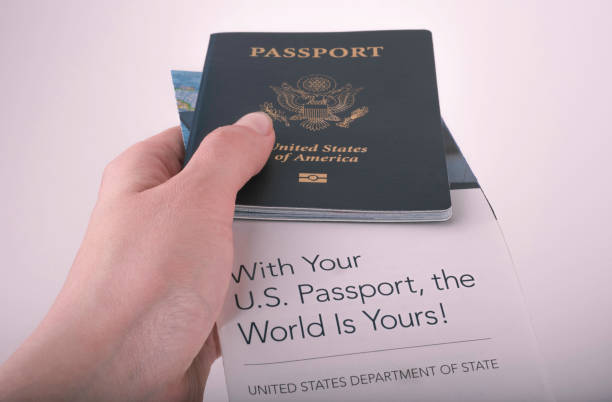 International American Passport (USA) covered piece of guide for new holders - With Your US Passport, the world is Yours! International American Passport (USA) holding in hand and covered piece of guide for new holders by United States Department of states - With Your US Passport, the world is Yours! blue us passport cover stock pictures, royalty-free photos & images
