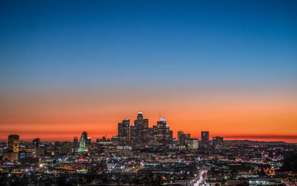 LA skyline at dusk The colors of sunset turning to night over downtown Los Angeles, California. city of los angeles stock pictures, royalty-free photos & images
