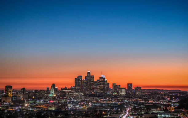 LA skyline at dusk The colors of sunset turning to night over downtown Los Angeles, California. city of los angeles los angeles county skyline city stock pictures, royalty-free photos & images