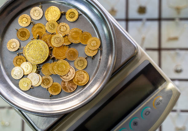 Close-up of gold coins on weighing scale Close-up of gold coins on weighing scale mass unit of measurement photos stock pictures, royalty-free photos & images