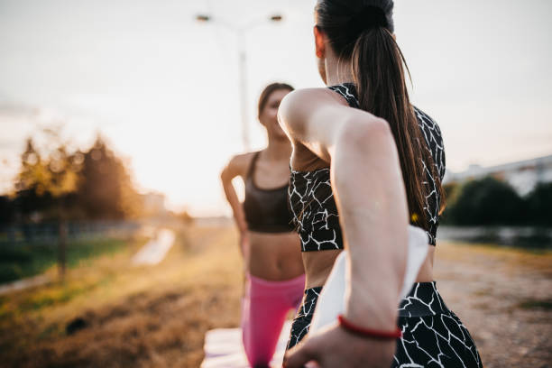istock Young women perform yoga moves 1275310332