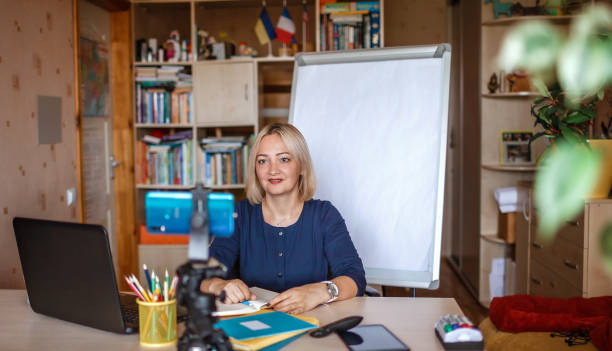 istock Distant education. Middle aged teacher giving online lesson via internet at home 1275310839