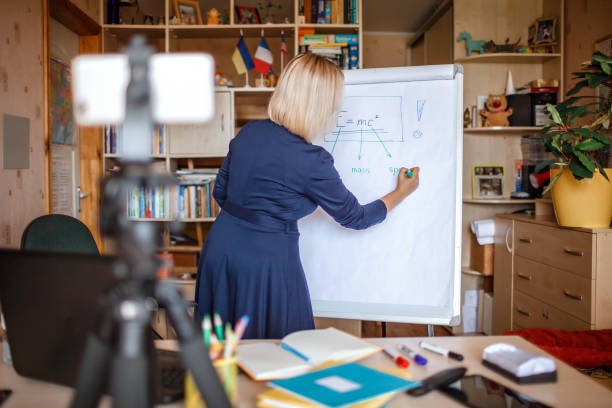 istock Distant education. Middle aged teacher giving online lesson via internet at home 1275310841
