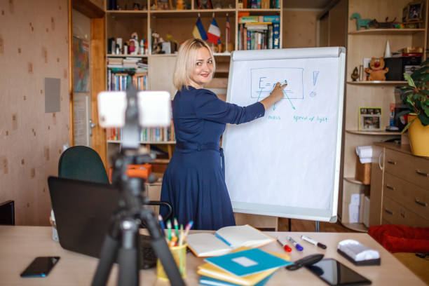 istock Distant education. Middle aged teacher giving online lesson via internet at home 1275310909