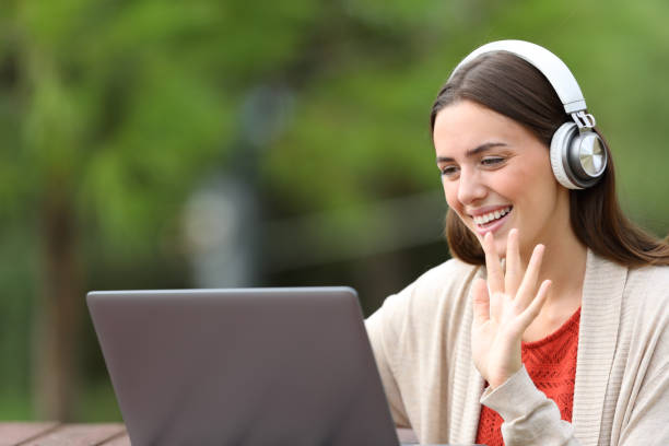 istock Happy woman using laptop greeting in a video call 1275312683