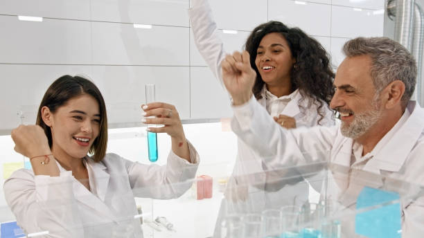 istock Multi ethnic laboratory team celebrating breakthrough in research 1275316795