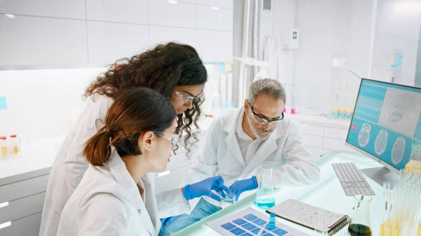 istock Research laboratory. Multi ethnic team discussing the course of experiment 1275316937
