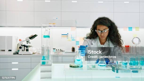 African Female Scientist Working On Laboratory Glassware Stock Photo - Download Image Now