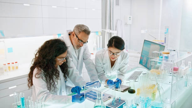 istock Research laboratory interior with medical samples. Multi ethnic team comparing test results 1275317445