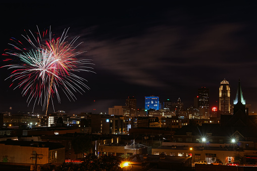 Fireworks explode over the Des Moines, Iowa skyline. The Financial Center and stand out in the skyline.
