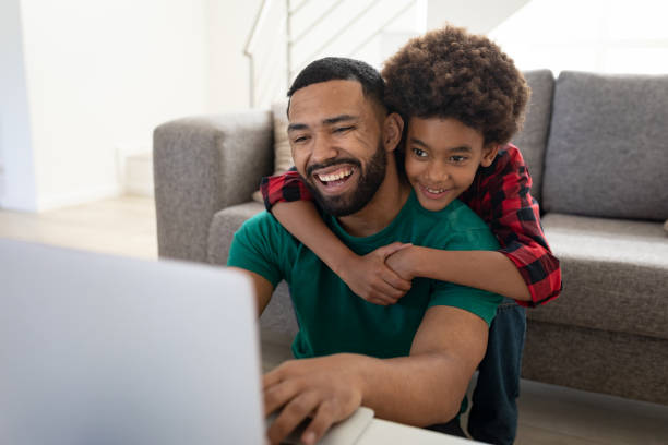 istock Father and son using laptop at home 1275326637