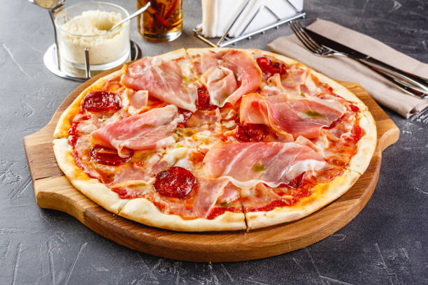 istock Pizza with salami and prosciutto 1275335902