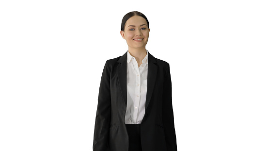Medium shot. Front view. Confident Businesswoman walking towards looking at camera with a smile on white background. Professional shot in 4K resolution. 043. You can use it e.g. in your medical, commercial video, business, presentation, broadcast