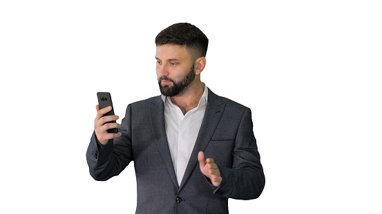Medium shot. Front view. Handsome businessman walking and recording story for a social network on white background. Professional shot in 4K resolution. 044. You can use it e.g. in your medical, commercial video, business, presentation, broadcast