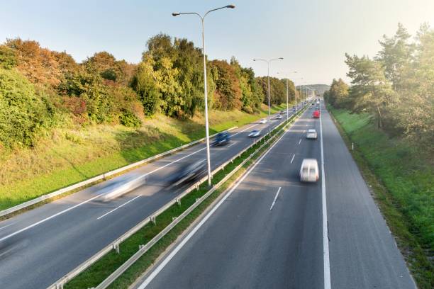 car street road traffic transport. car driving on freeway at sunrise, motion blur. road to the city of brno - czech republic. road to the city. - sunrise city of sunrise street road imagens e fotografias de stock