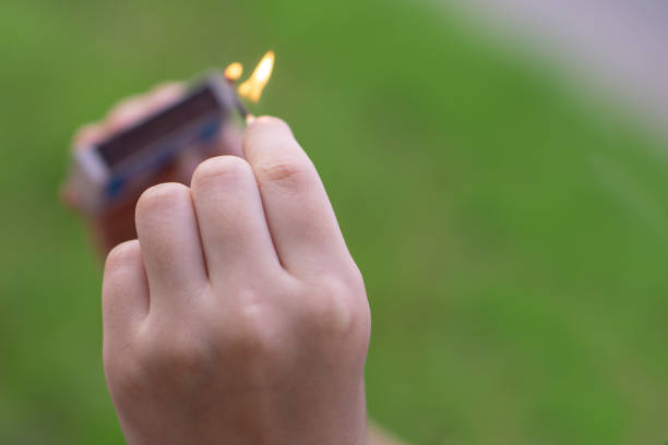 child's hand with a blurred burning match - fire match women flame imagens e fotografias de stock