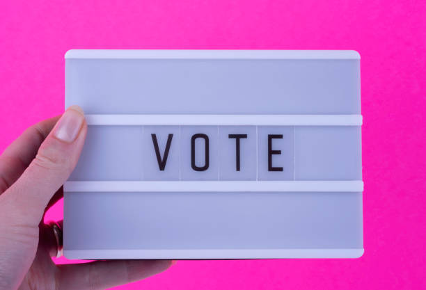 istock Lightbox with lettering - Vote- on pink background. Election concept. 1275357798