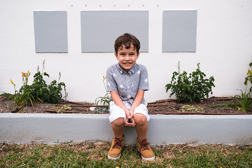 Cute smiling boy outdoor portrait in a home setting.