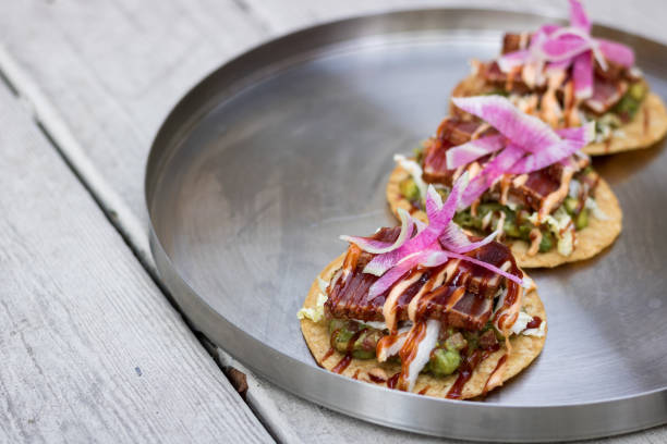 There Tuna Toast BBQ Ahi Tuna Tostadas with corn salsa, guacamole and chipotle dre stock pictures, royalty-free photos & images