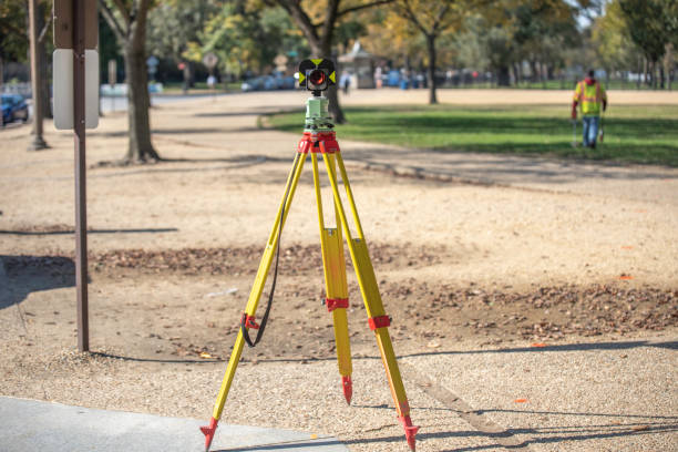 istock Modern Surveying total station on tripod, close up view on blurred park background. 1275371835