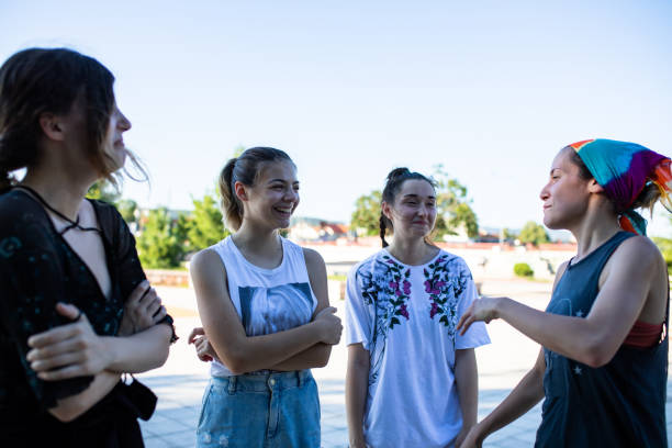 istock Young women having fun talking in a park 1275382882