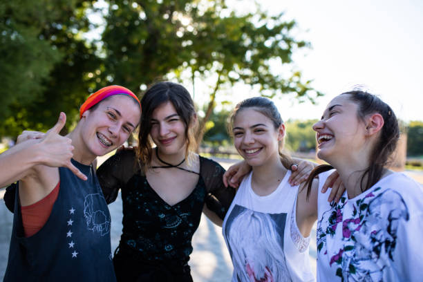 istock Four young women smiling and hugging each other 1275383214