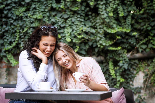 istock Happy women best friends talking together drinking coffee 1275383543