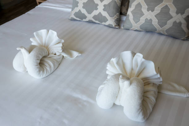 istock White swan blanket origami decoration on the bed. 1275398573